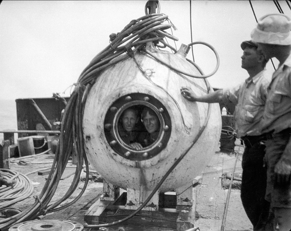 William Beebe and Otis Barton in the bathysphere, two faces pressed close behind the porthole of a machine built to look the abyss in the eye.