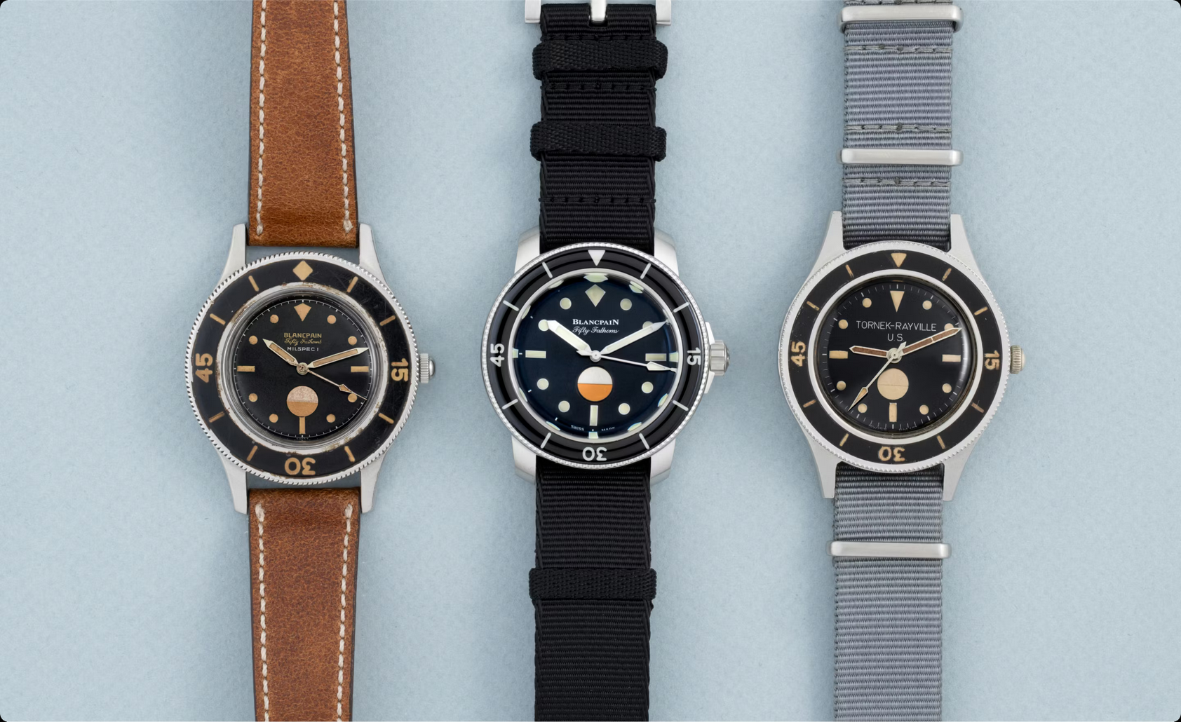 Three interpretations of the Fifty Fathoms, recalling the line running from military tool to dive instrument to horological icon.